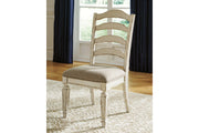 Realyn Chipped White Oval Dining Table and 4 Ladder Back Chairs from Ashley - Luna Furniture