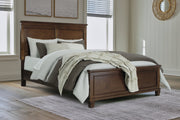 Danabrin Queen Panel Bed with Mirrored Dresser and Chest in Brown - PKG015179