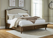 Sturlayne Queen Upholstered Panel Bed with Mirrored Dresser and Chest in Brown from Ashley - Luna Furniture