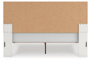 Zuraleus King Upholstered Panel Platform Bed and Dresser in White - PKG022821